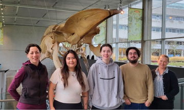 All five of the making connections team-members photographed in front of the whale. From left to right: Bridgette, Mailyn, Riley, Fabio, and Jackie